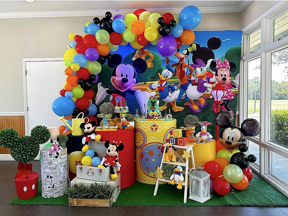 Mickey Mouse Clubhouse birthday setup with colorful balloon arch