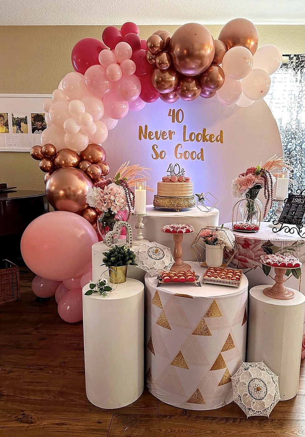 Rose gold 40th birthday setup with pink and copper balloons